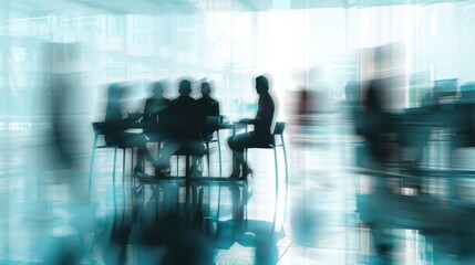 A group of business professionals in silhouette are seated around a table in a modern office setting. A sense of movement and energy is conveyed through the blurred background and dynamic composition.