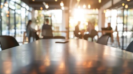 A wooden table in a cafe setting with blurred people and chairs in the background, the sun shines through the windows.