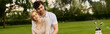 © LIGHTFIELD STUDIOS - Stylish couple posing on lush park lawn, exuding timeless elegance and old money charm.