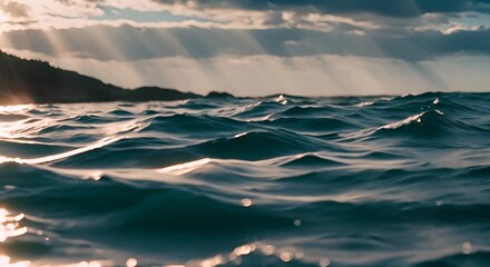 Poster - Sunlight reflecting on the surface of the ocean, creating a beautiful play of light and shadow on the water with dramatic clouds in the background