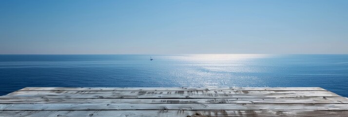 Wall Mural - A weathered wooden table sits at the edge of a cliff, offering a stunning view of the vast, shimmering sea. A single sailboat is visible in the distance