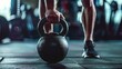 © Kate Mayer - Closeup of athletic man holding black iron kettlebell in a crossfit training on fitness center or in a gym