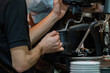 © alicobanoglu - Coffee machine and milk frothing barista