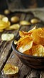© iVGraphic - Bowl of crispy potato chips on rustic wooden table, close-up, food photography concept