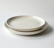 © Riya - Sleek White Ceramic Plate Set on Minimalist Display