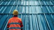 © Emin - Construction engineer in safety gear inspecting metal roofing at an industrial site with empty space for text