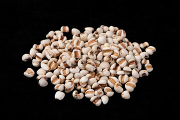 Wall Mural - job's tears seed isolated on black background