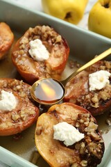 Poster - Tasty baked quinces with nuts, honey and cream cheese in dish, closeup