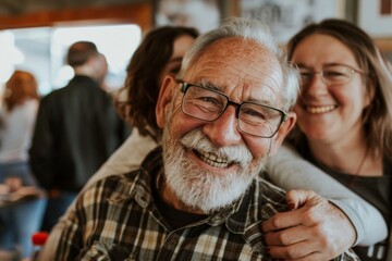 Wall Mural - Portrait of senior man with his friends in background at home.