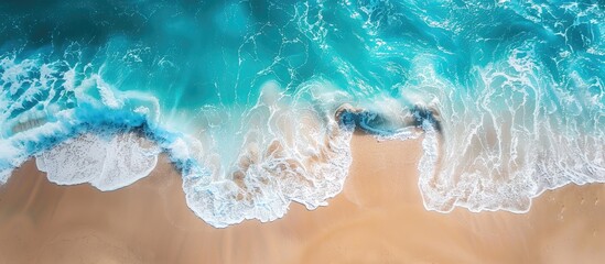 Wall Mural - Aerial View of Turquoise Ocean Waves Crashing on Sandy Beach