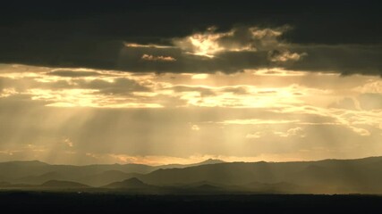 Wall Mural - sunset in the mountains with sun rays and clouds