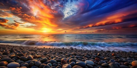 Wall Mural - Sunset over colorful pebbled beach with dramatic sky and waves, sunset, pebbled beach, colorful, dramatic sky, waves, nature, tranquil, serene, water, ocean, scenic, beautiful, natural