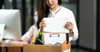 © NAMPIX - Resign From Job Or Fired Employee Moving Out Of Office, Frustrated Fired Asian Employee Woman Packing Belongings In Cardboard Box