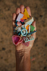 Wall Mural - Coastal Micro Plastic Pollution held in a hand from Hawaii Beaches