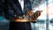 © Atchariya63 - Businessperson using a tablet with data and graphs overlayed, representing modern technology and analysis.