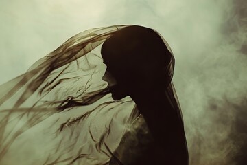 Wall Mural - Ethereal silhouette of a woman wearing a veil blowing in the wind.