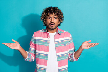Wall Mural - Photo of confused impressed man wear trendy striped clothes raise hands wtf isolated on cyan color background
