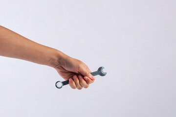 Wall Mural - Hand holding a wrench isolated on white background.