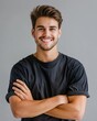 © Vlad - Young Man Portrait. Handsome Smiling Man with Folded Arms in Studio Shot