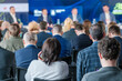 © Anton Gvozdikov - A group of people attentively listening during a business conference or seminar. The event features professional speakers and engaged attendees.
