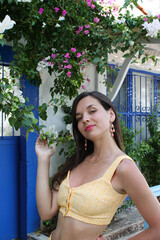 Wall Mural - Young woman brunette near greek style building