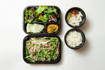 Wall Mural - Stir-fried meat and side dishes in packaging containers, Korean food