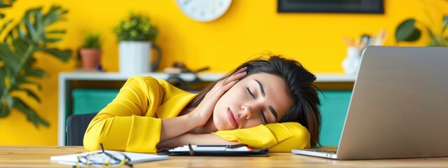 A woman is sleeping on a desk with a laptop and a clock in the background. Concept of exhaustion and the need for rest