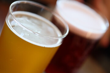 A close-up view of two glasses of beer