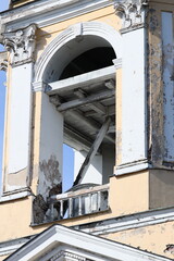 Poster - Abandoned building with a broken window and a clock, great for use in scenes of decay or nostalgia
