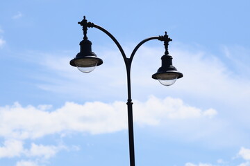 Poster - Two street lights standing together on a city sidewalk, can be used for urban or nighttime scenes