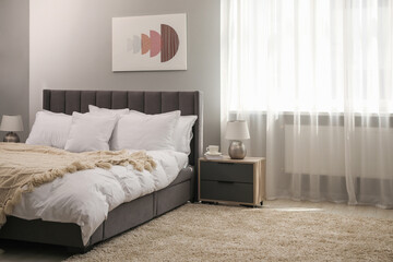 Wall Mural - Many soft white pillows and knitted blanket on bed indoors