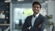 © Bijac - confident young indian businessman in modern office smiling with arms crossed 3d illustration