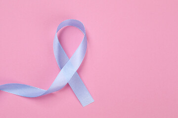 Wall Mural - International Psoriasis Day. Ribbon as symbol of support on pink background, top view. Space for text