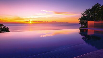 Canvas Print - A serene desktop wallpaper featuring an infinity pool overlooking a tranquil ocean at sunset, with soft orange and purple hues reflecting in the water.