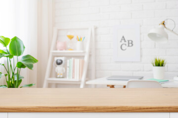 Wall Mural - cropped shot of wooden table with copy space in blurred study room