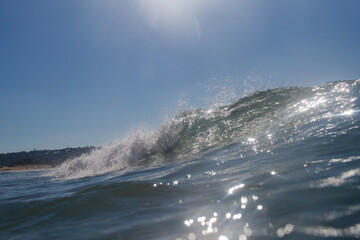 Wall Mural - Breaking wave on the ocean on a sunny day.