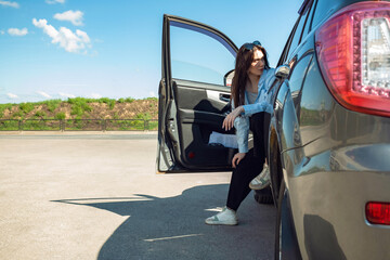 Wall Mural - The girl is sitting in the car.