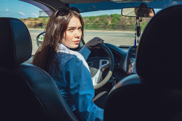 Wall Mural - The girl is sitting in the car.