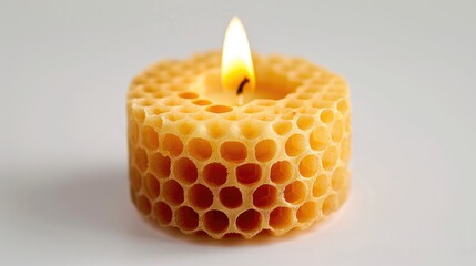 A solitary wax candle in honeycomb octagon shape on white background