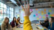 © pkproject - Engaged Participant Raising Hand in Bright Conference Room