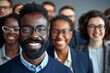 © Yuliia - Smiling multi-ethnic group of business people wearing eyeglasses and one man with a well-groomed beard on gray background.