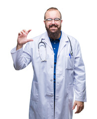 Sticker - Young caucasian doctor man wearing medical white coat over isolated background smiling and confident gesturing with hand doing size sign with fingers while looking and the camera. Measure concept.