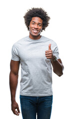 Sticker - Afro american man over isolated background doing happy thumbs up gesture with hand. Approving expression looking at the camera with showing success.