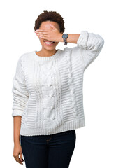 Sticker - Beautiful young african american woman wearing sweater over isolated background smiling and laughing with hand on face covering eyes for surprise. Blind concept.