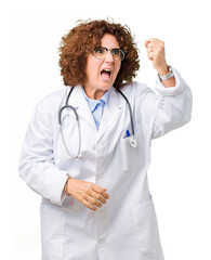 Poster - Middle ager senior doctor woman over isolated background angry and mad raising fist frustrated and furious while shouting with anger. Rage and aggressive concept.