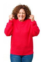 Sticker - Beautiful middle ager senior woman red winter sweater over isolated background excited for success with arms raised celebrating victory smiling. Winner concept.