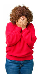 Canvas Print - Beautiful middle ager senior woman red winter sweater over isolated background with sad expression covering face with hands while crying. Depression concept.