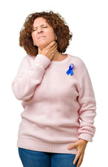 Wall Mural - Middle ager senior woman wearing changeable blue color ribbon awareness over isolated background Touching painful neck, sore throat for flu, clod and infection