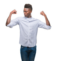 Canvas Print - Young african american man over isolated background showing arms muscles smiling proud. Fitness concept.