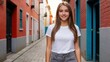 © QuoDesign - Teenage girl wearing white t-shirt and grey jeans standing in a city alley